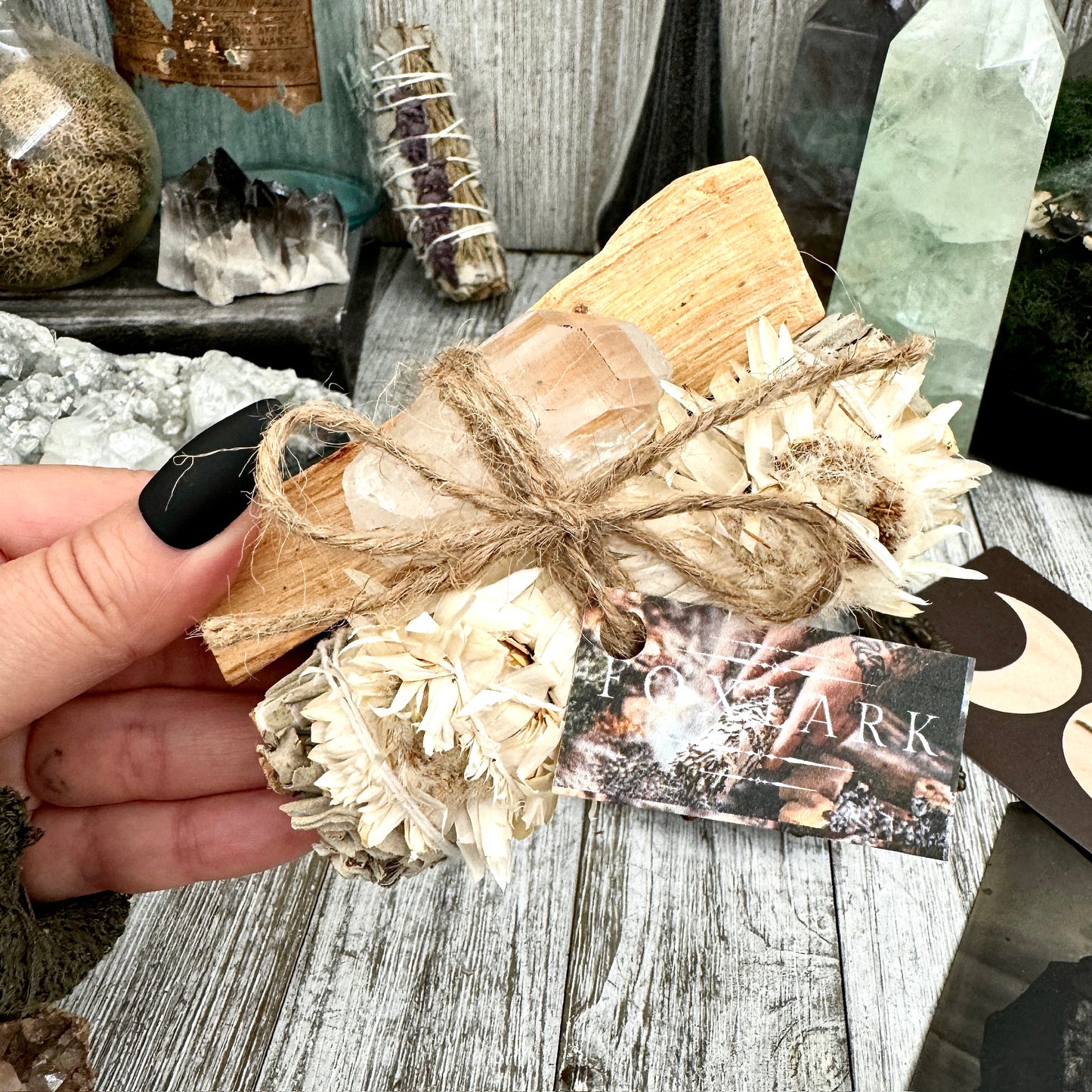 Wrapin sage bundle and crystal point, natural healing herbs with a clear quartz crystal, wrapped in eco-friendly packaging.