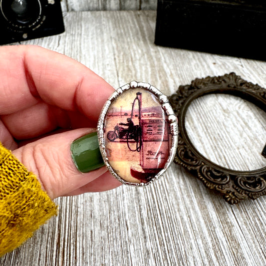 Vintage silver motorcycle and gas pump ring by FOXLARK, size 6.5, featuring detailed, one-of-a-kind design for motorcycle enthusiasts.