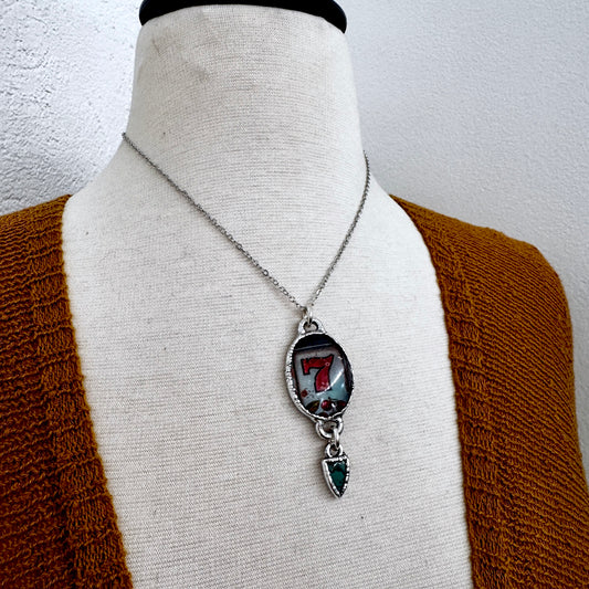 FOXLARK Lucky Number 7 slot machine necklace with turquoise charm in fine silver, showcasing detailed craftsmanship and vibrant color.