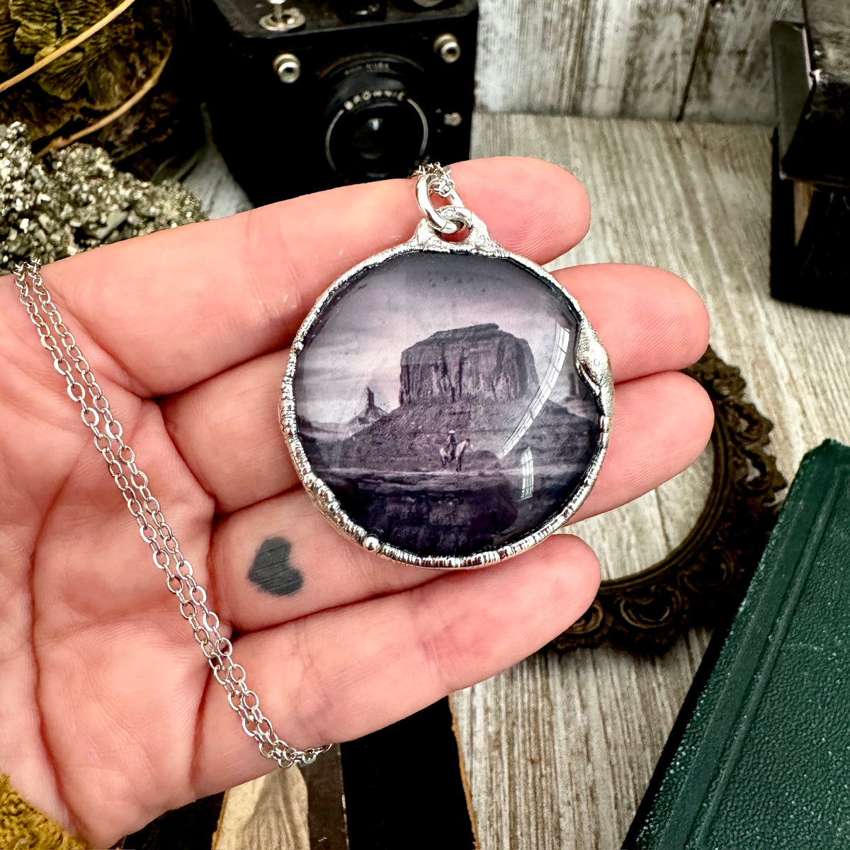 Fine silver necklace featuring a cowboy on horseback in a desert scene, crafted by FOXLARK, one-of-a-kind jewelry piece.