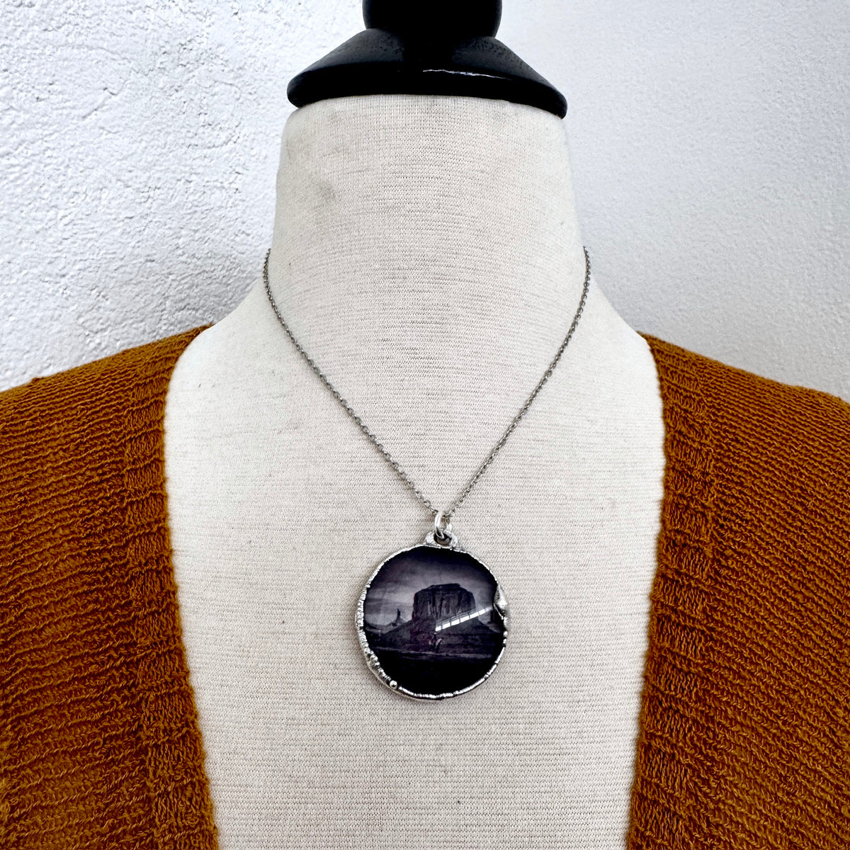 Fine silver necklace featuring a cowboy on horse and desert scene, handcrafted by FOXLARK, one-of-a-kind cowboy jewelry.