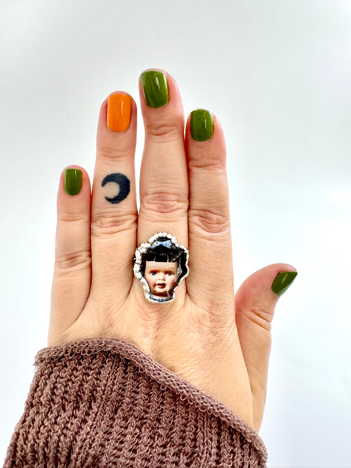 Blue bow doll head statement ring in fine silver, size 9, from FOXLARK's Weirdlings Collection, featuring detailed doll face design.