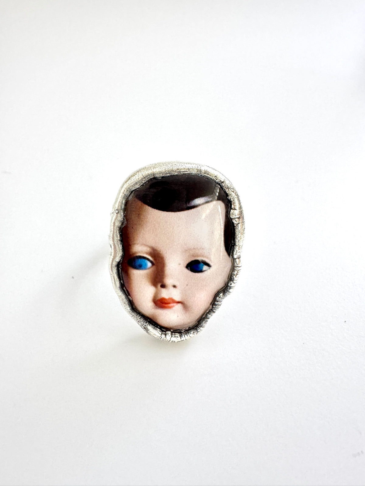 Silver Doll Head Statement Ring in size 10.5 from FOXLARK's Weirdlings Collection, featuring intricate doll head design on a fine silver band.