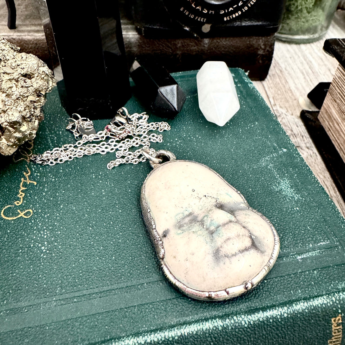 Fine silver ceramic baby doll face necklace from FOXLARK collection, featuring a unique, handcrafted design with detailed craftsmanship.