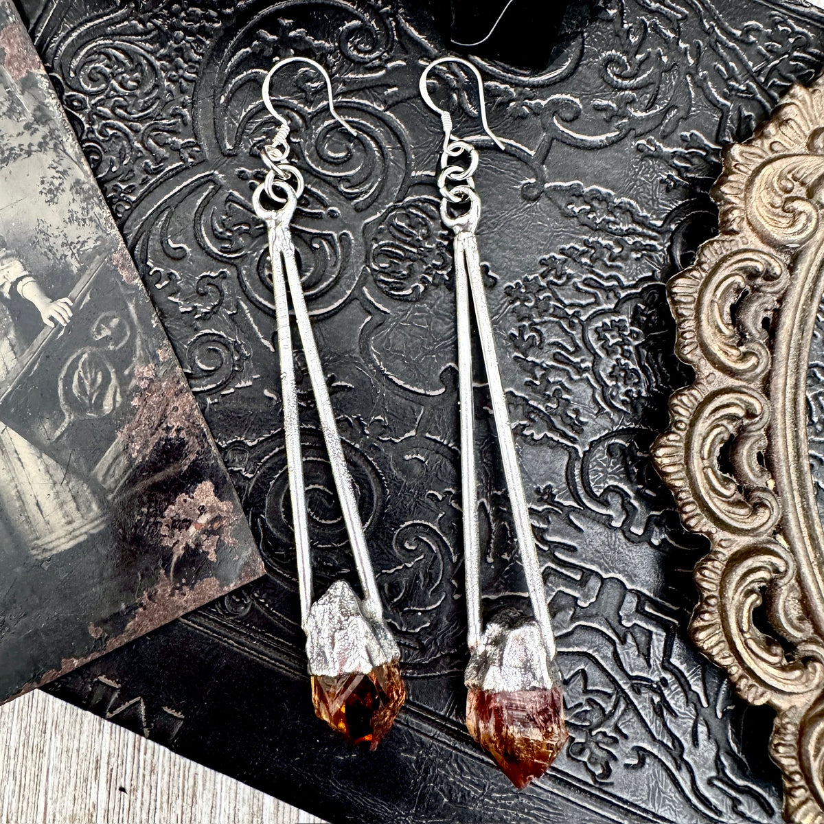 FOXLARK raw citrine crystal silver dangle earrings with long, witchy-inspired design, featuring shimmering gemstone accents.