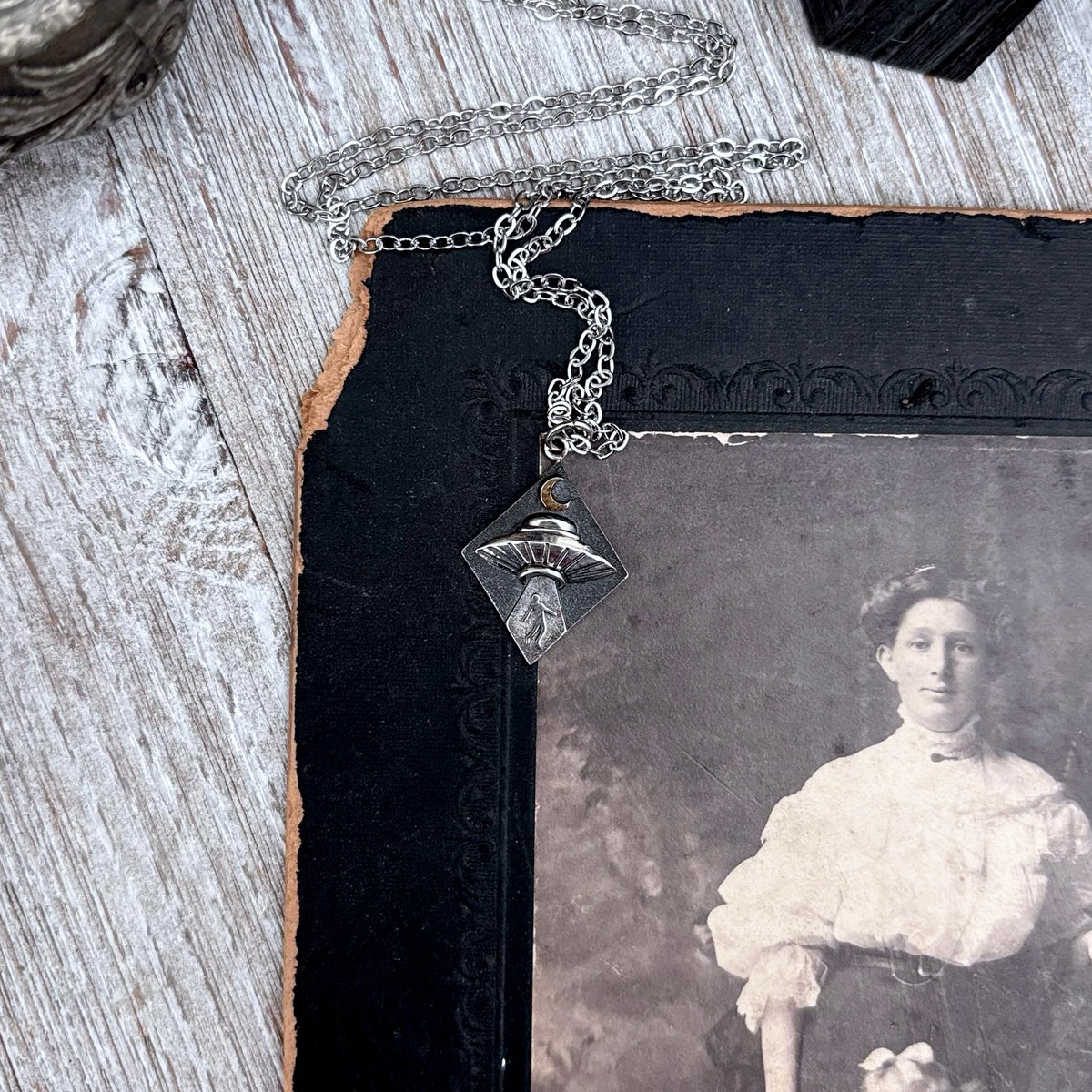 Sterling silver UFO abduction pendant from FOXLARK's Tiny Talisman Collection, featuring a detailed alien spacecraft design.