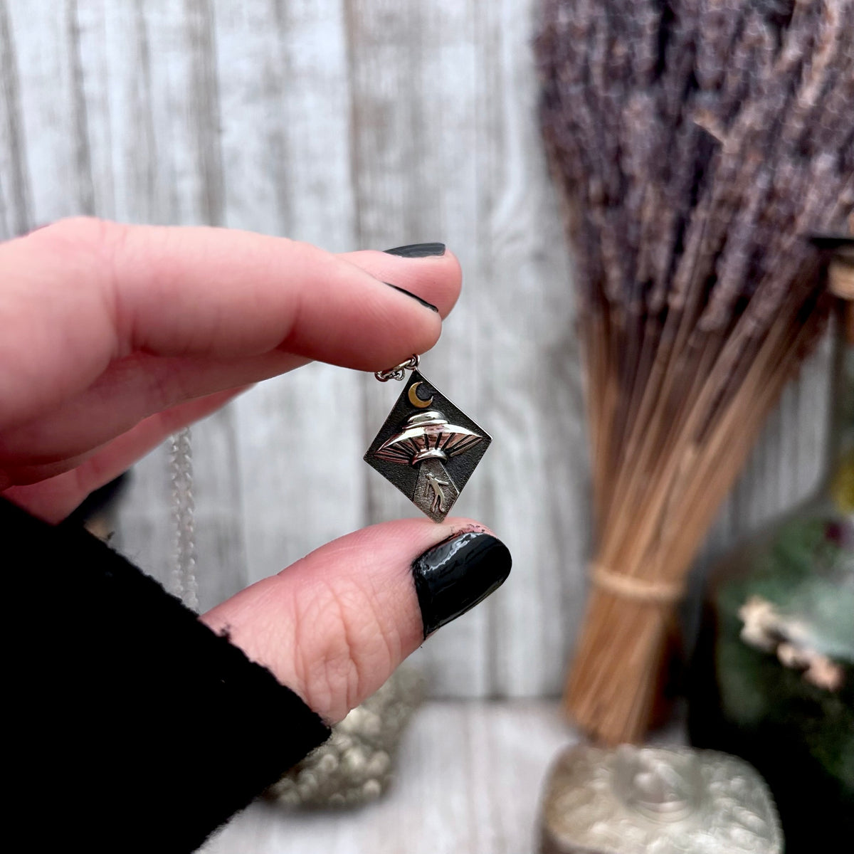 Sterling silver UFO abduction necklace pendant from FOXLARK's Tiny Talisman Collection, featuring a detailed alien spacecraft design.