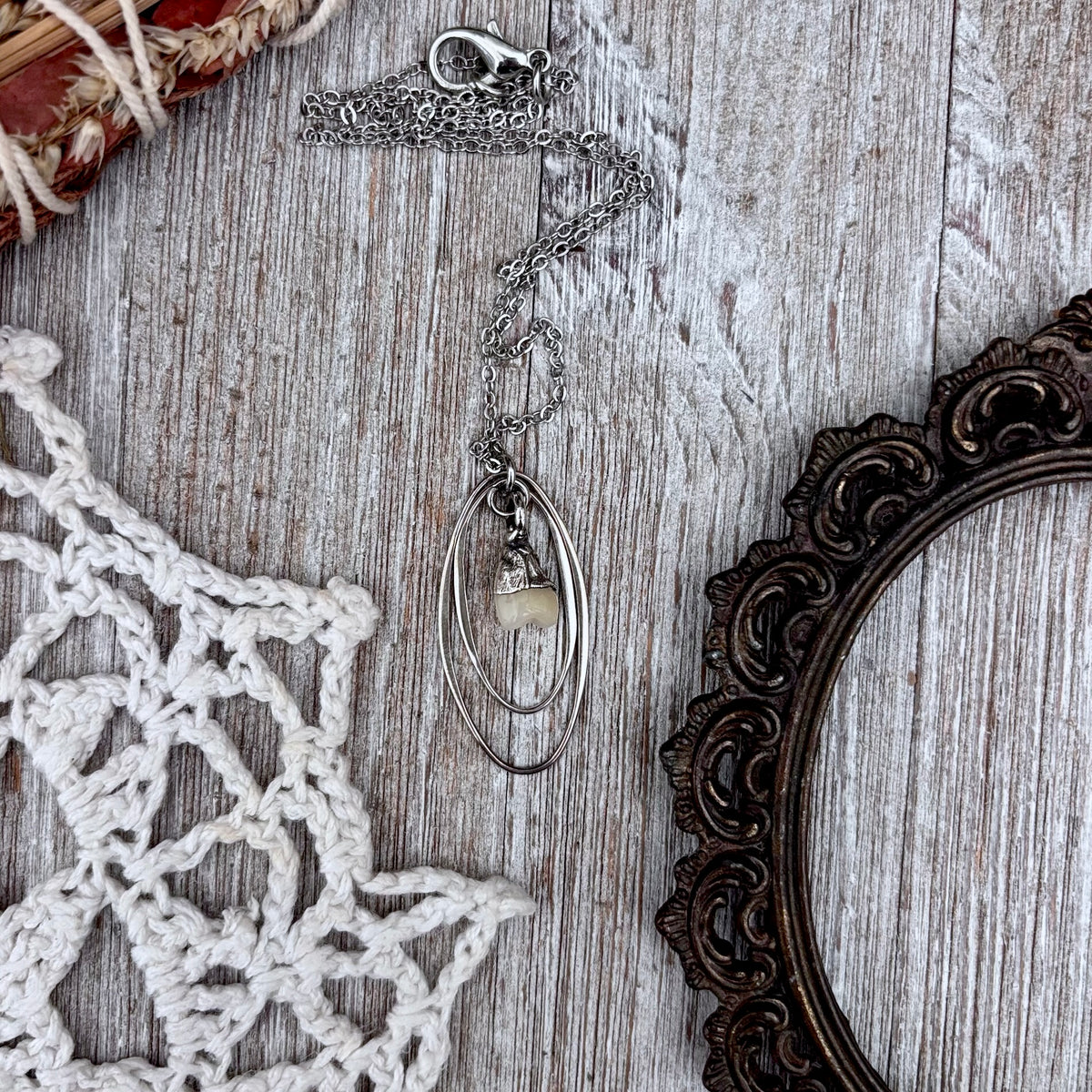 Tiny faux tooth talisman necklace from FOXLARK's sterling silver Talisman Collection, featuring a small, detailed tooth pendant.