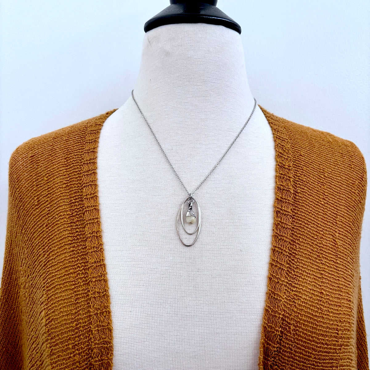 Tiny sterling silver faux tooth talisman necklace from FOXLARK's Talisman Collection, featuring detailed miniature tooth charms.