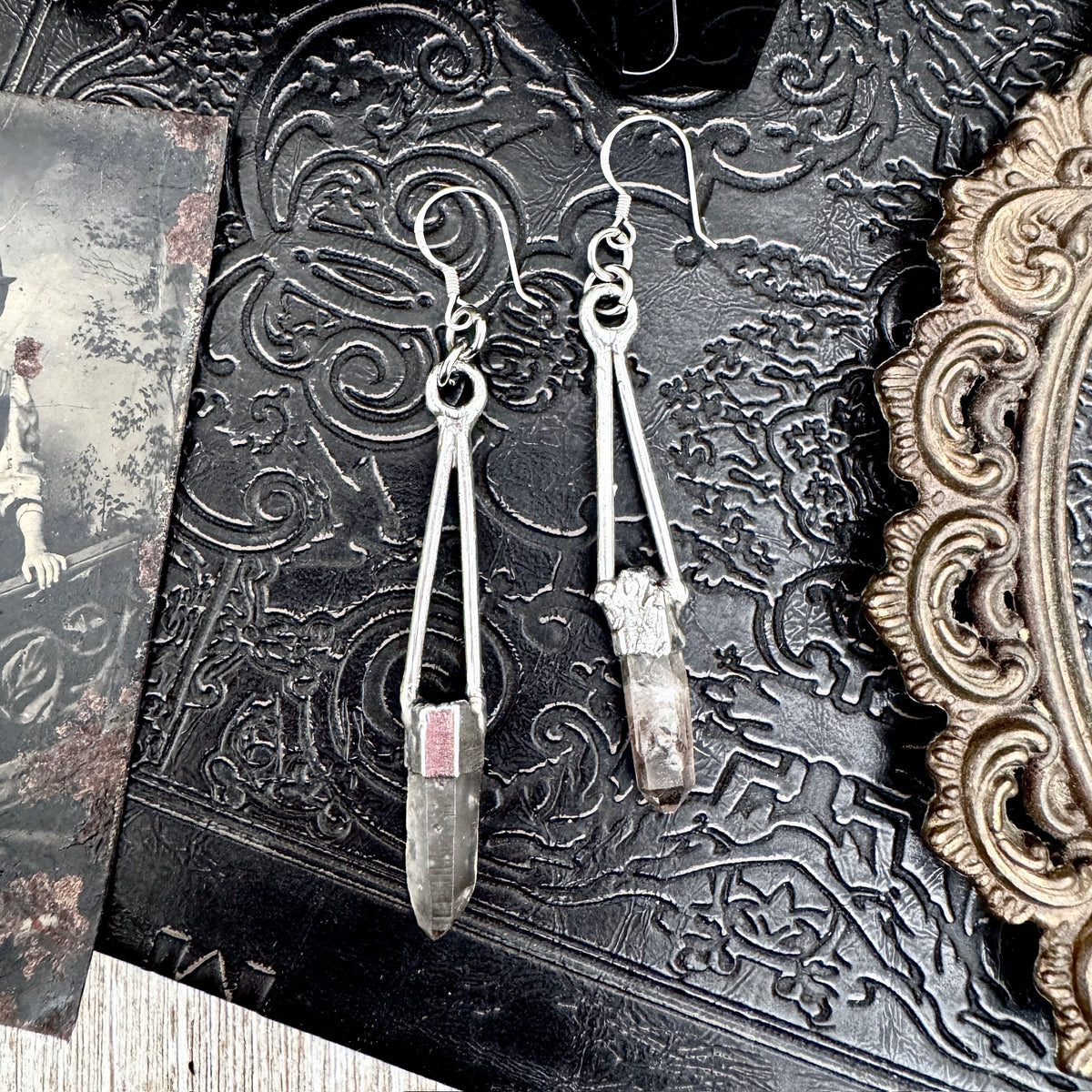 Raw smoky quartz dangle earrings with fine silver crystals, long witchy style earrings by FOXLARK displayed on a white background.