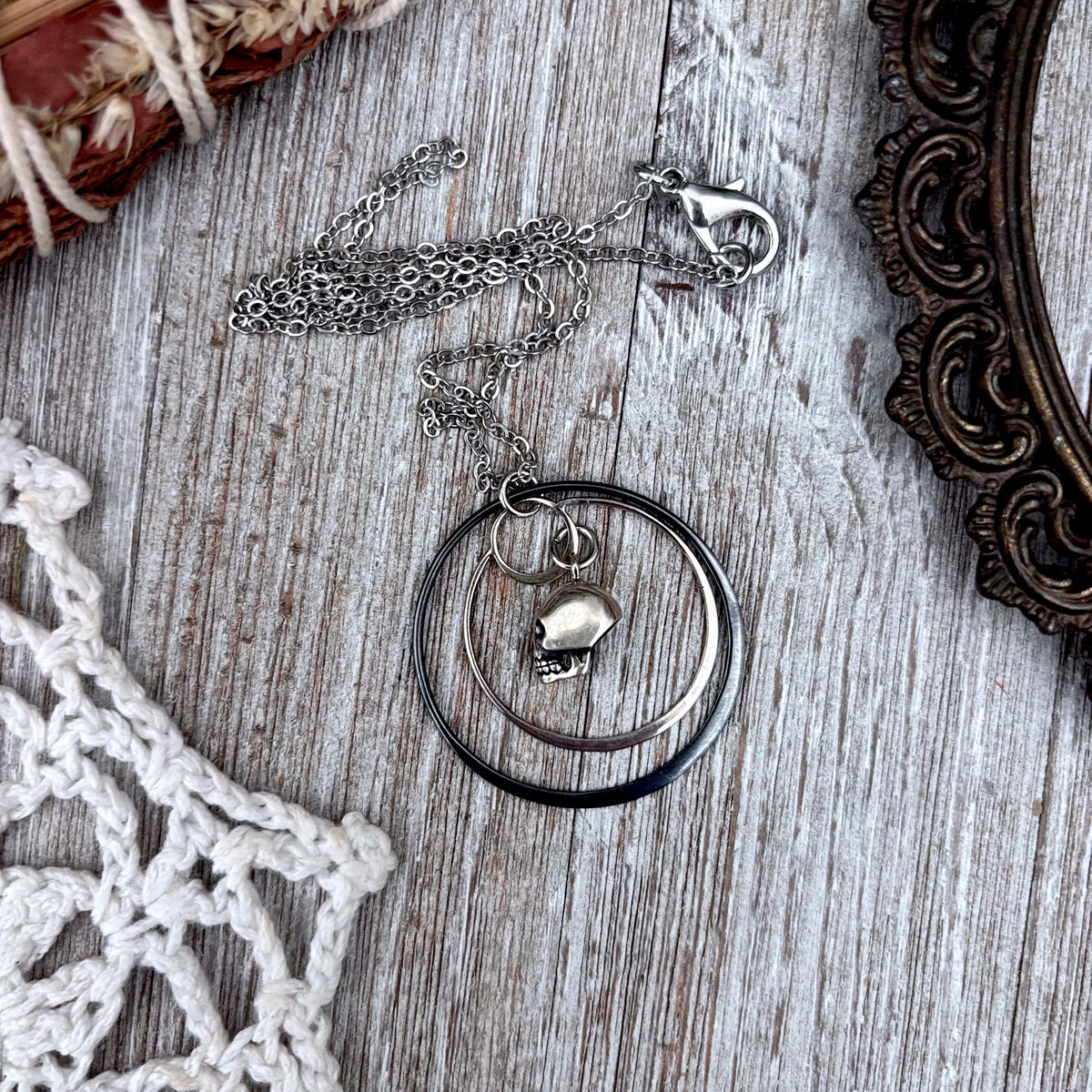 Tiny sterling silver human skull talisman necklace from FOXLARK's Talisman Collection, featuring detailed skull pendant.