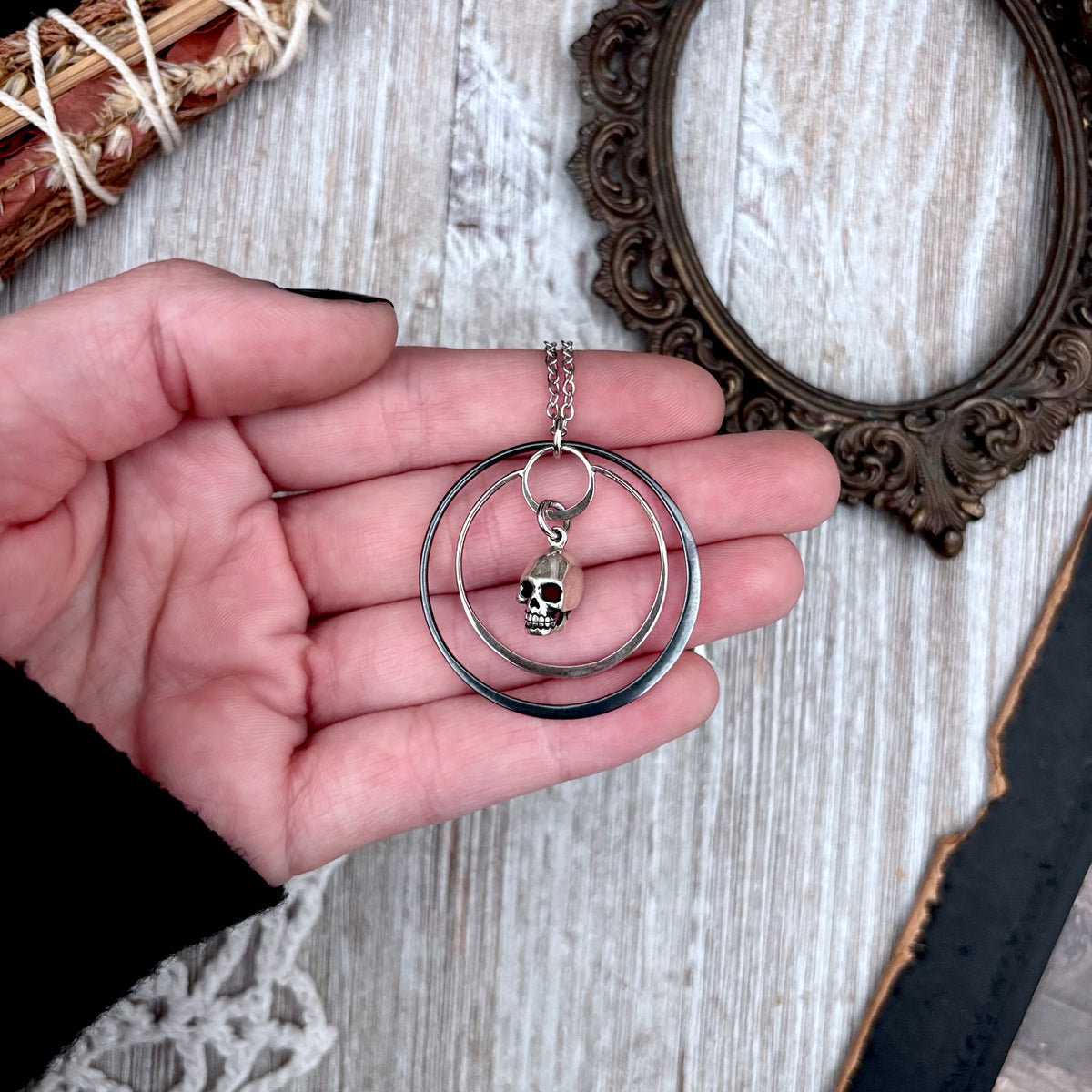 Tiny sterling silver human skull talisman necklace from FOXLARK's Talisman Collection, featuring detailed skull pendant.