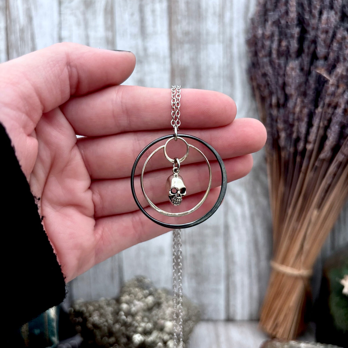 Tiny sterling silver human skull talisman necklace from FOXLARK's Talisman Collection, featuring a detailed skull pendant.