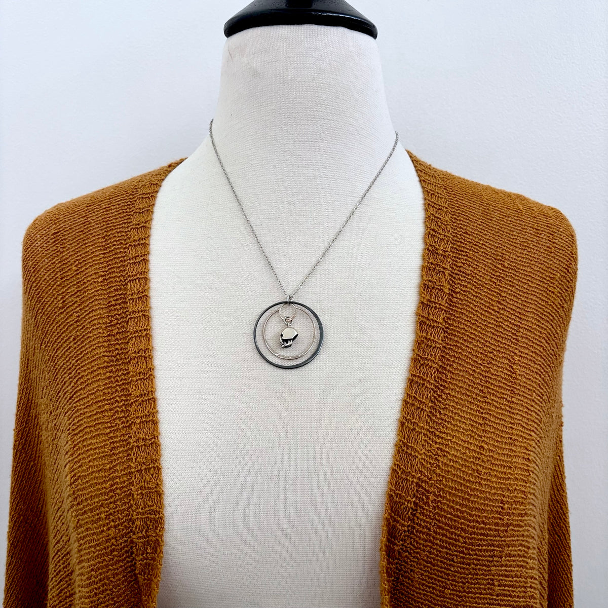 Tiny sterling silver human skull talisman necklace from FOXLARK's Talisman Collection, featuring detailed skull pendant.