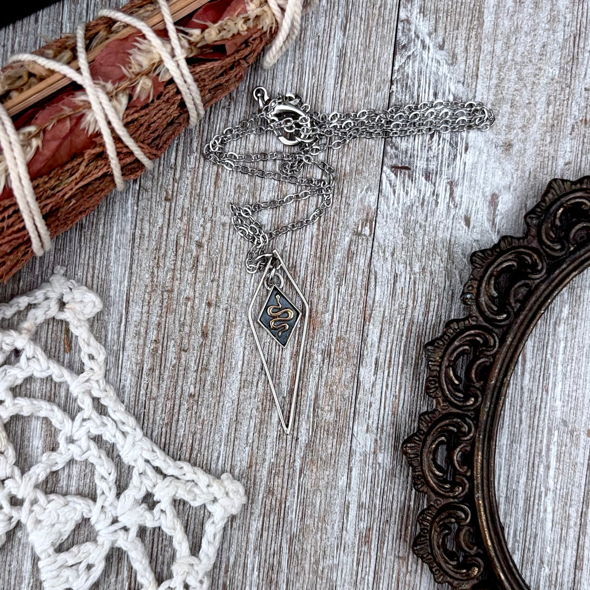 Tiny sterling silver snake talisman necklace from FOXLARK's Talisman Collection featuring a detailed diamond snake design.