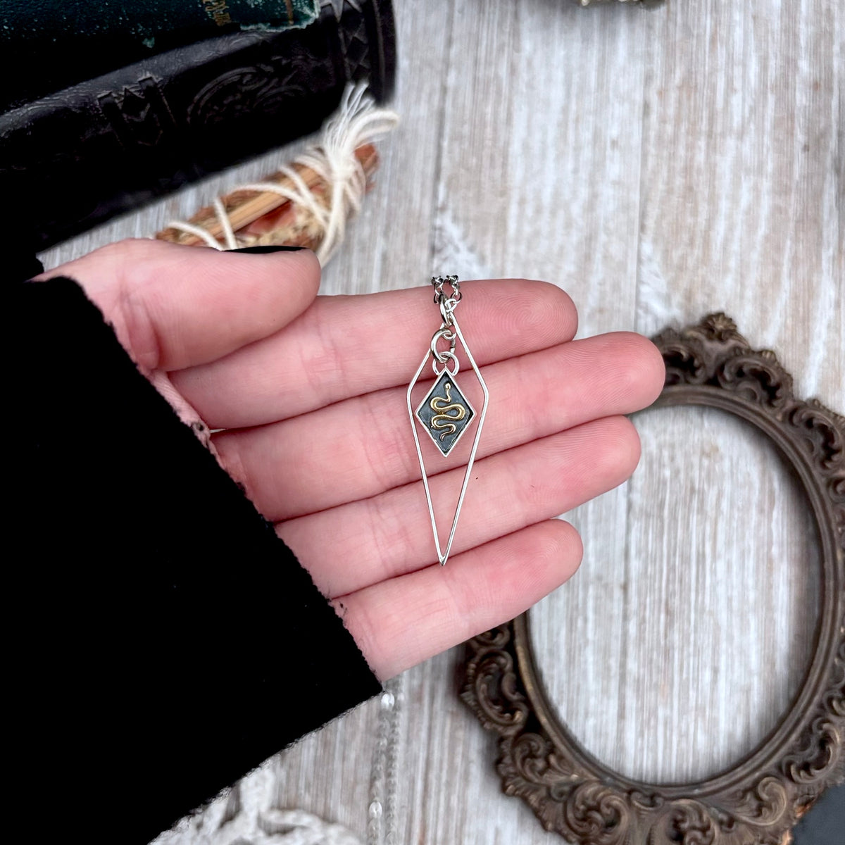 Tiny sterling silver diamond snake talisman necklace from FOXLARK's Talisman Collection, featuring a detailed snake pendant.