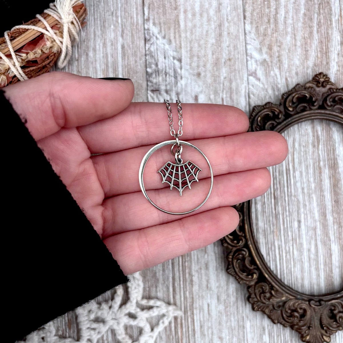 Tiny sterling silver spider web talisman necklace from FOXLARK's Talisman Collection, featuring a delicate web charm.