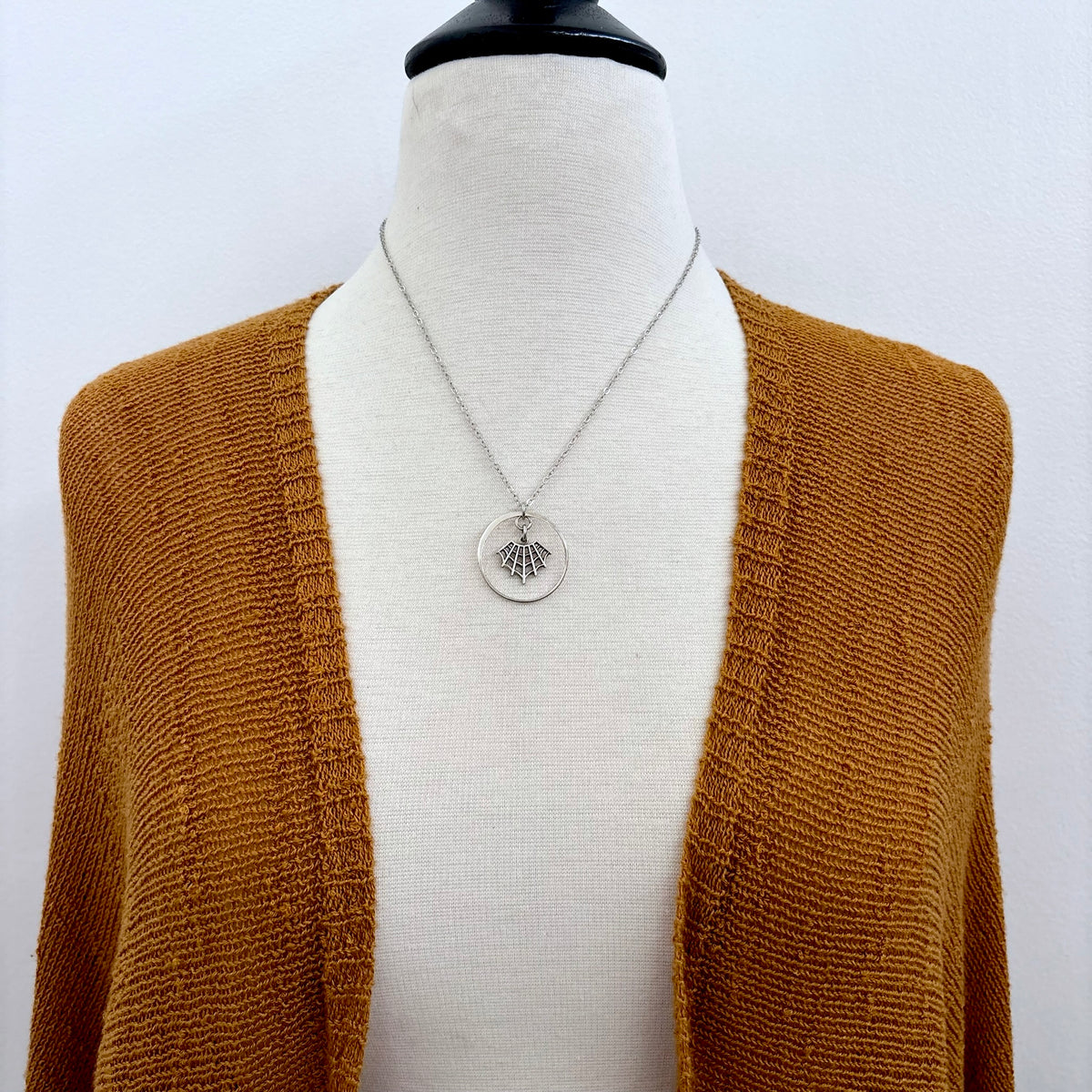 Tiny sterling silver spider web talisman necklace from FOXLARK's talisman collection, featuring intricate web design.