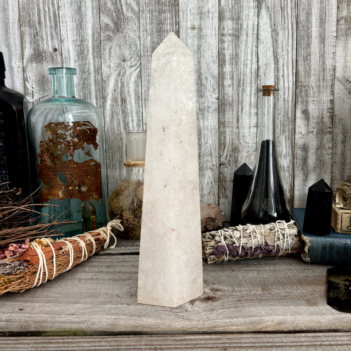 Large clear quartz crystal point standing upright, natural self-standing crystal from FoxlarkCrystals, showcasing its transparent, pointed formation.
