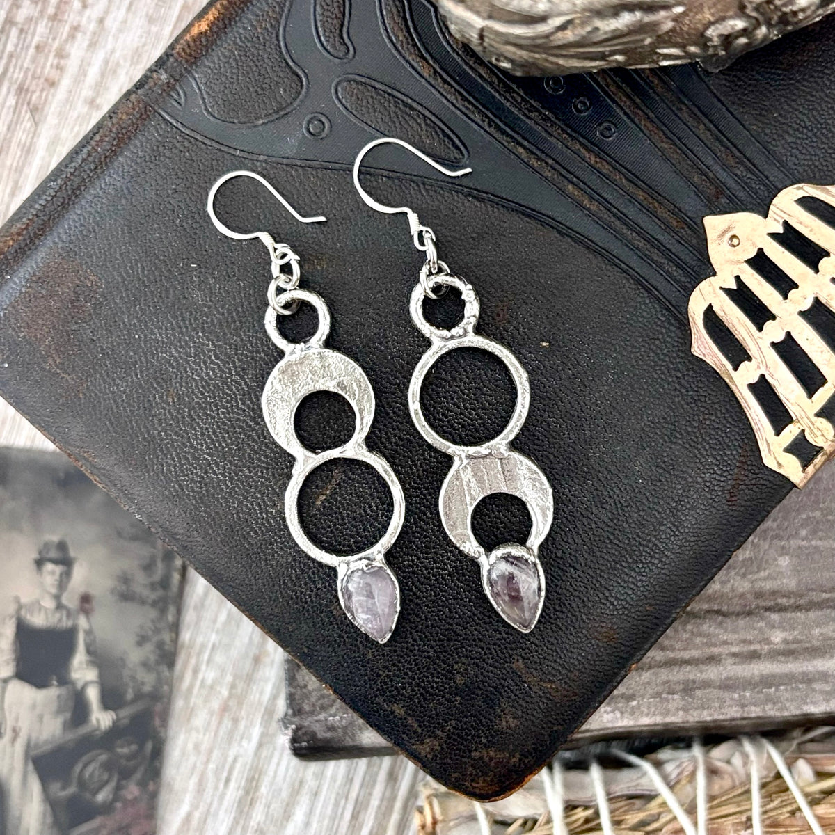 Amethyst crystal dangle earrings with silver hooks by FOXLARK, featuring long witchy-style design and intricate gemstone details.