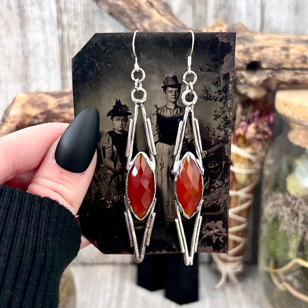 Carnelian and silver long dangle witchy earrings by FOXLARK featuring crystal accents and intricate design.