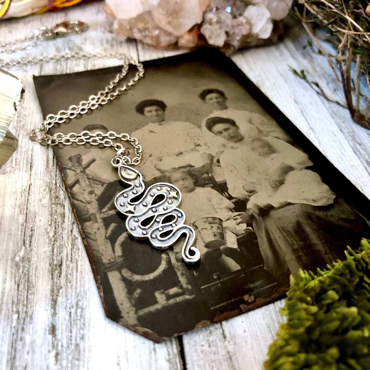 Sterling silver snake pendant with bronze moon and stars from the Tiny Talisman Collection by FOXLARK, 33x15mm.