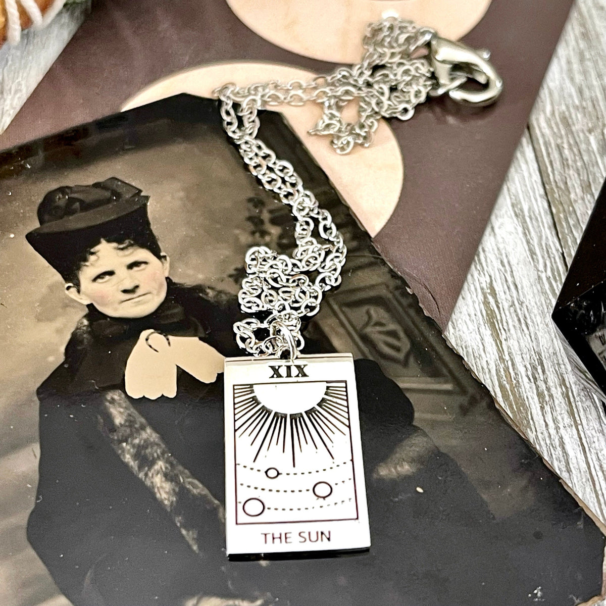 Sterling silver Sun Tarot Card necklace from FOXLARK's Tiny Talisman Collection, featuring a 24x14mm detailed sun design.