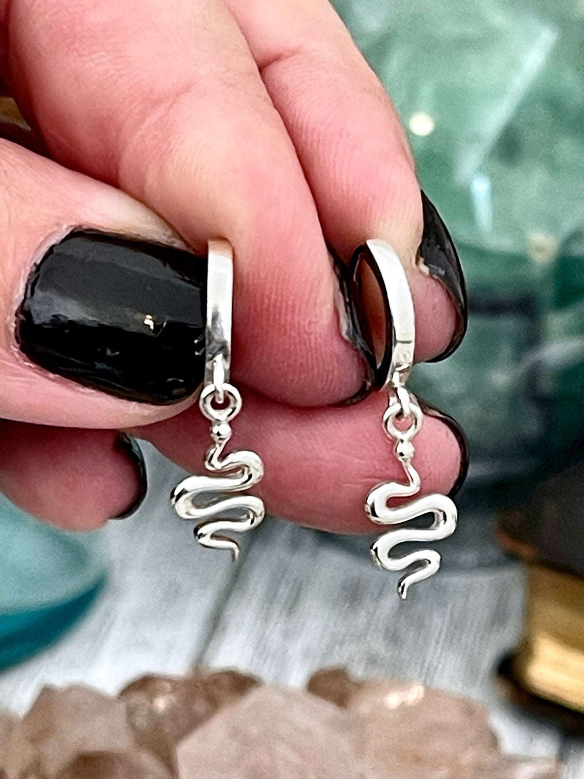 Sterling silver FOXLARK huggie hoop earrings with mini snake design, 27x11mm, showcasing detailed, shiny silver jewelry.