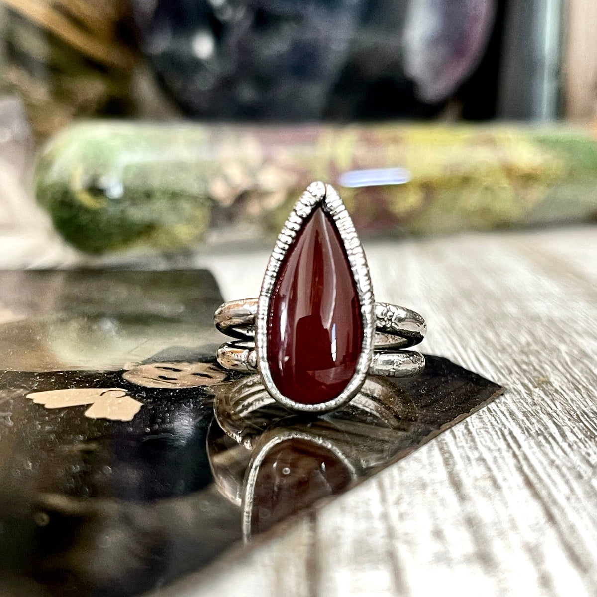 Red Carnelian teardrop ring by FOXLARK in fine silver, available in sizes 6 to 11, featuring a polished teardrop gemstone setting.