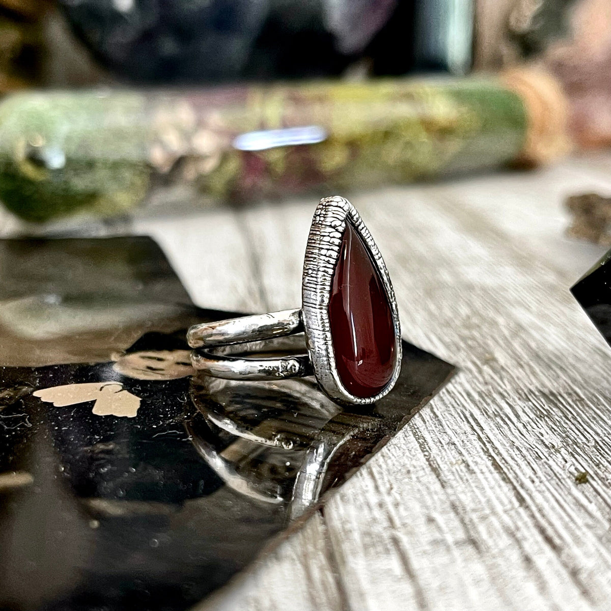 Red carnelian teardrop ring by FOXLARK featuring fine silver band available in sizes 6 to 11, showcasing elegant gemstone detail.