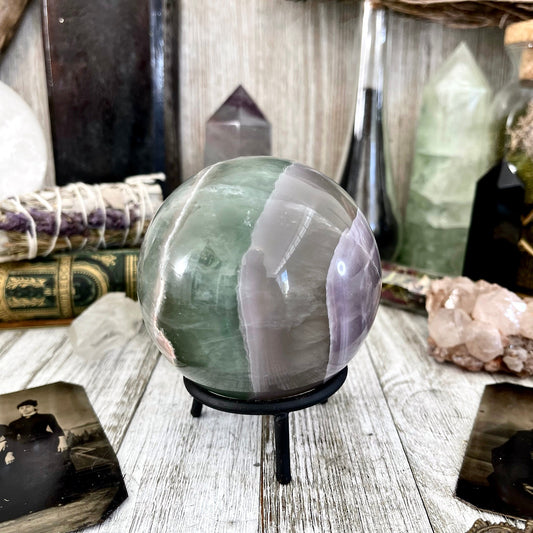 Large green fluorite crystal ball from FoxlarkCrystals, showcasing vibrant green hues and smooth polished surface.