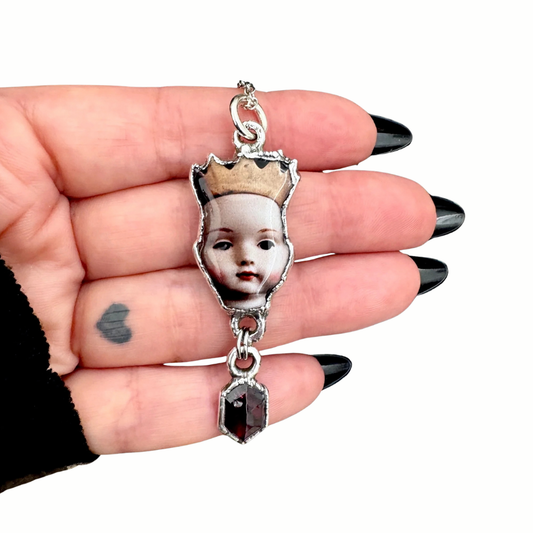 doll head necklace in fine silver with garnet