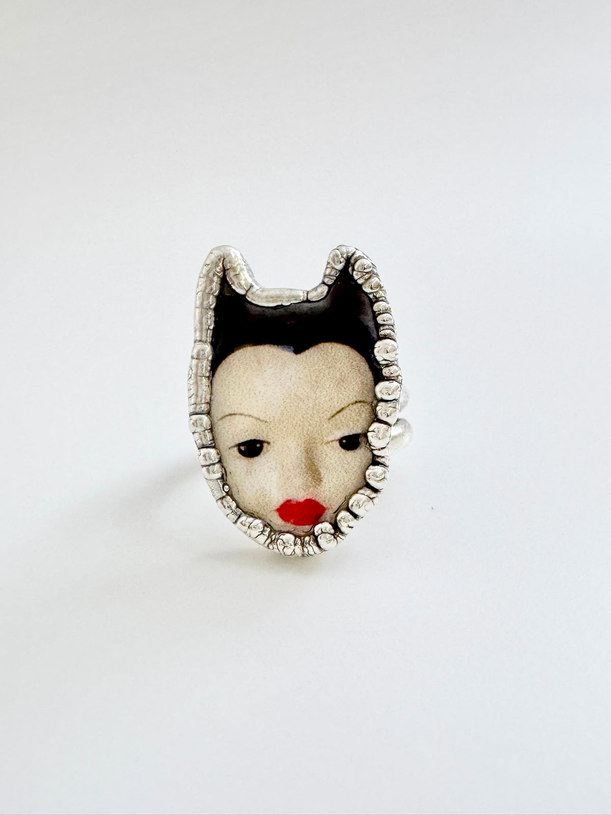 FOXLARK Weirdlings Collection doll head ring in fine silver, size 7, detailed sculpted silver jewelry featuring a whimsical face design.