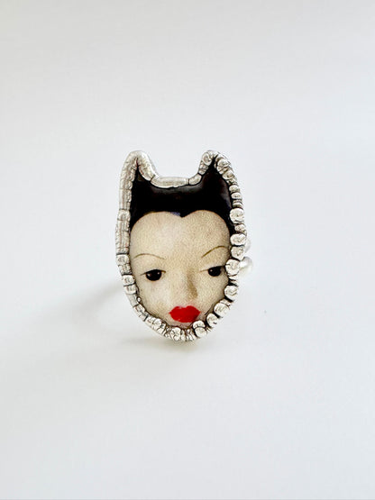 FOXLARK Weirdlings Collection doll head ring in fine silver, size 7, detailed sculpted silver jewelry featuring a whimsical face design.