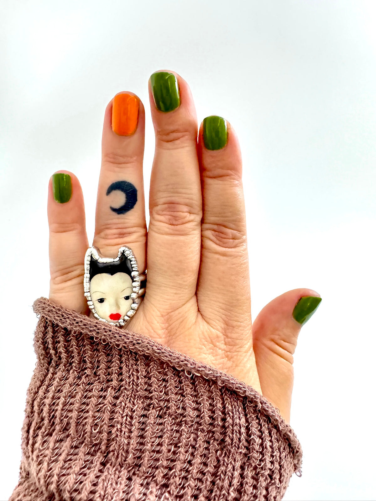 Silver doll head ring from FOXLARK's Weirdlings Collection, size 7, featuring detailed fine silver craftsmanship.