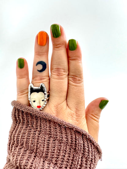 Silver doll head ring from FOXLARK's Weirdlings Collection, size 7, featuring detailed fine silver craftsmanship.