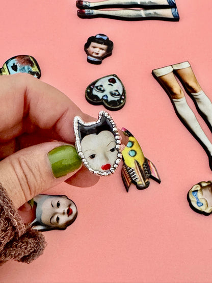 Foxlark Weirdlings Collection doll head ring in fine silver, size 7, featuring detailed doll head design on a silver ring.