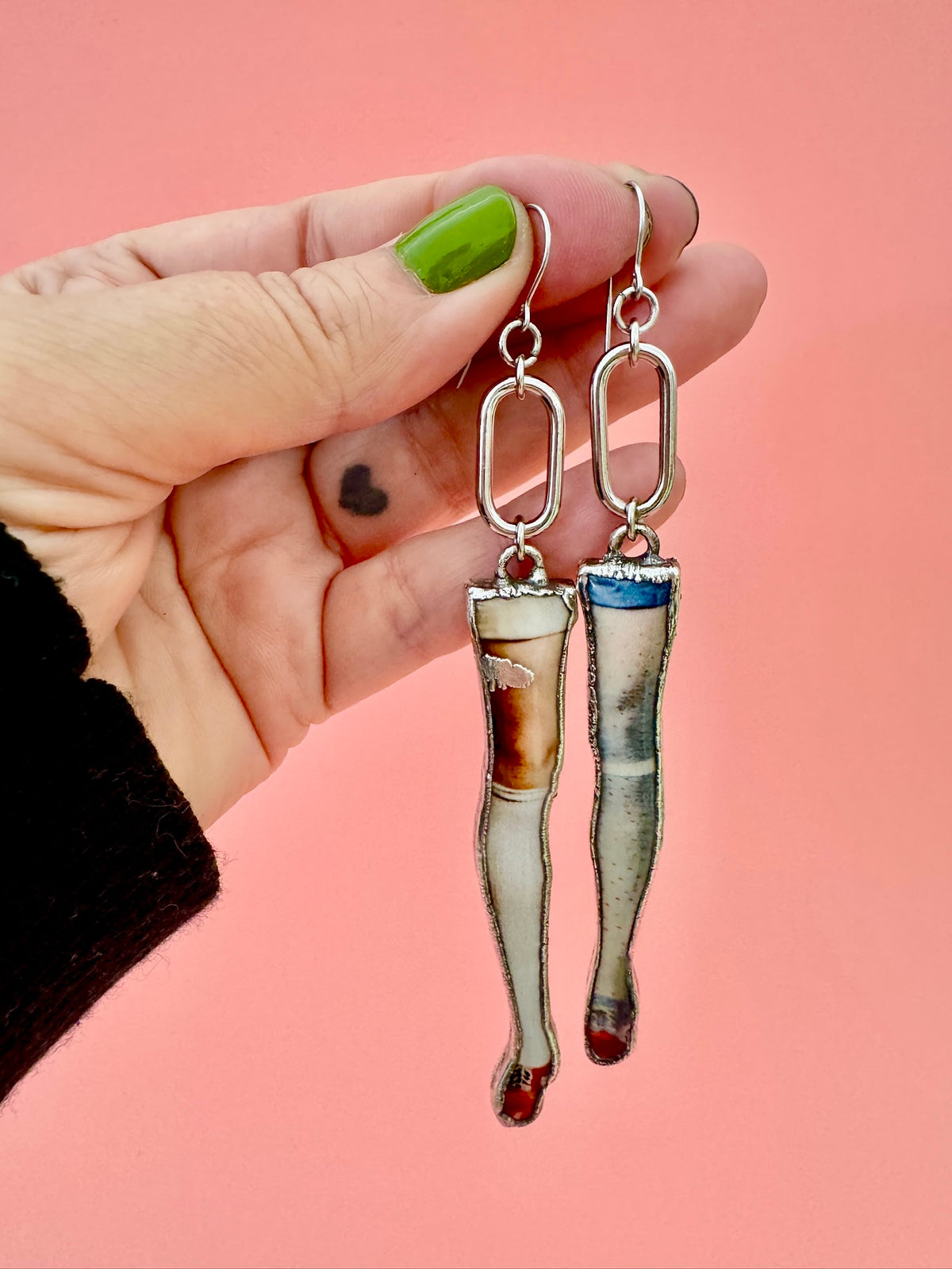Long dangle mismatched doll leg earrings in fine silver from FOXLARK's Weirdlings Collection, featuring quirky, artistic jewelry.