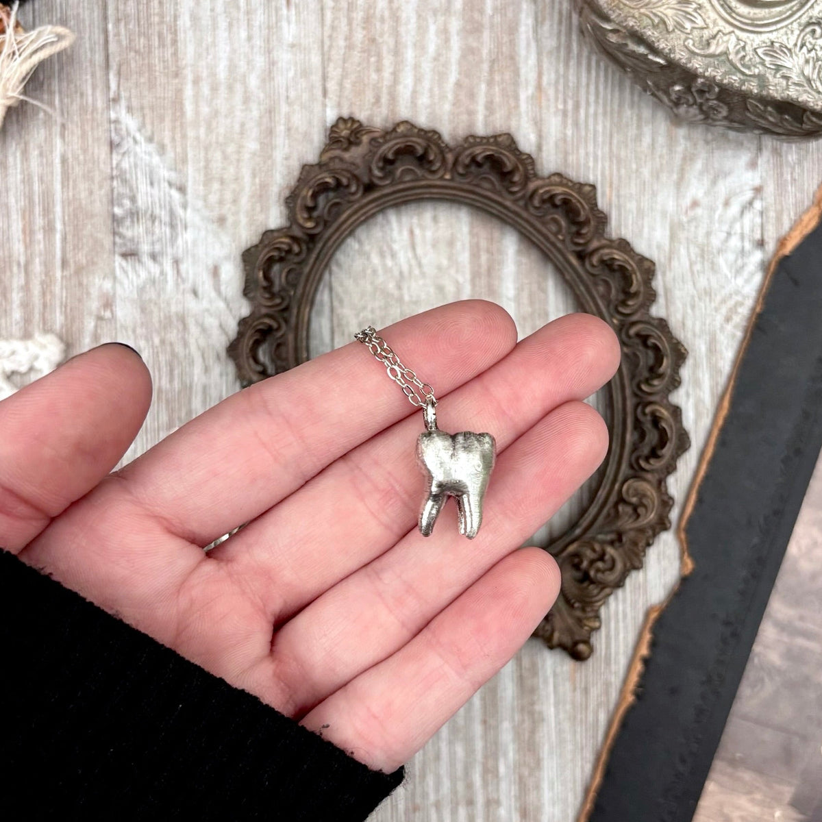 Silver tooth necklace from FOXLARK's Foxlark Collection, featuring a fine silver pendant on a delicate chain.