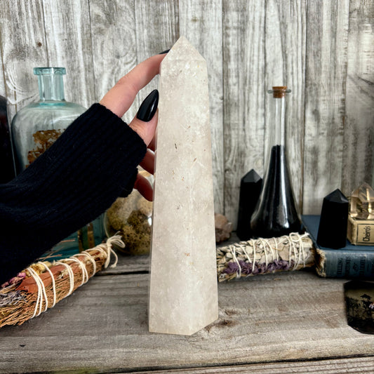 Large self-standing clear quartz crystal point from FoxlarkCrystals, showcasing a natural, polished quartz with pointed tip and transparent clarity.